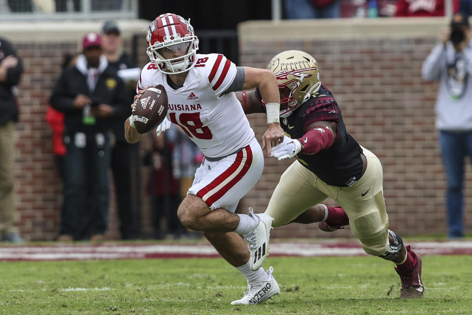 Louisiana quarterback Chandler Fields (18) scrambles right pursued by Florida State defensive lineman Jared Verse during the third quarter of an NCAA college football game on Saturday, Nov. 19, 2022, in Tallahassee, Fla. (AP Photo/Gary McCullough)