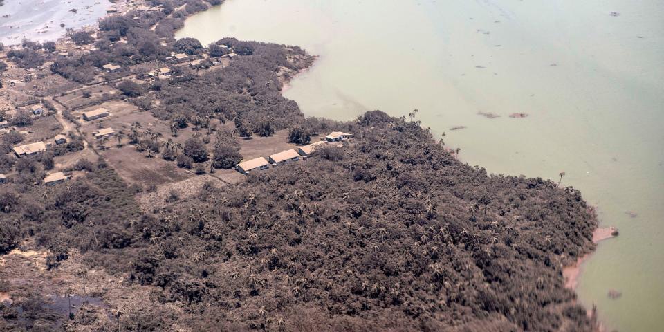 Volcanic ash covers roof tops and vegetation in an area of Tonga, Monday, Jan. 17, 2022.