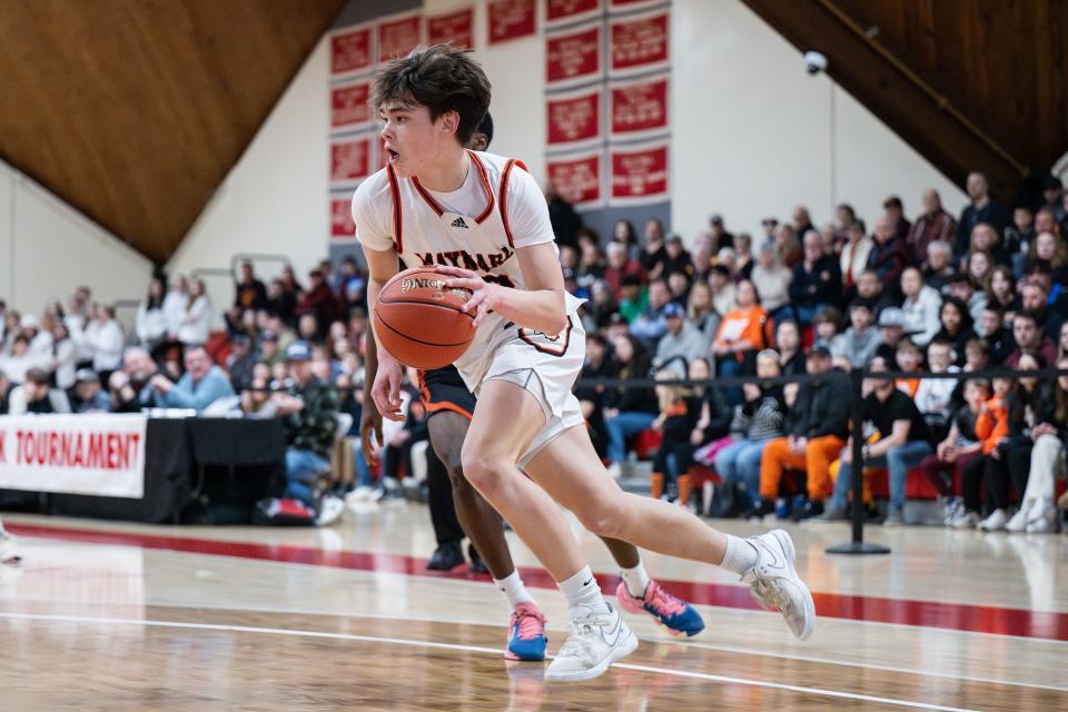 Maynard's Ryan McLaughlin drives versus David Prouty.