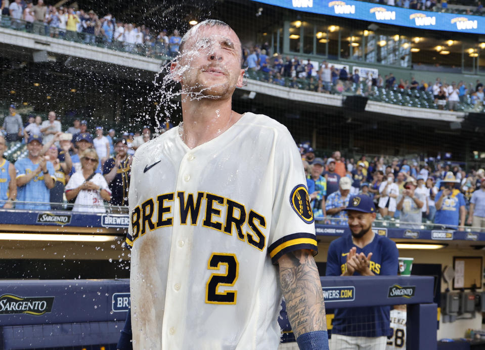 Milwaukee Brewers' Brice Turangn has gatorade dip from his face after he hit a game winning single against the Minnesota Twins in the tenth inning of a baseball game, Wednesday, Aug 23, 2023, in Milwaukee. (AP Photo/Jeffrey Phelps)