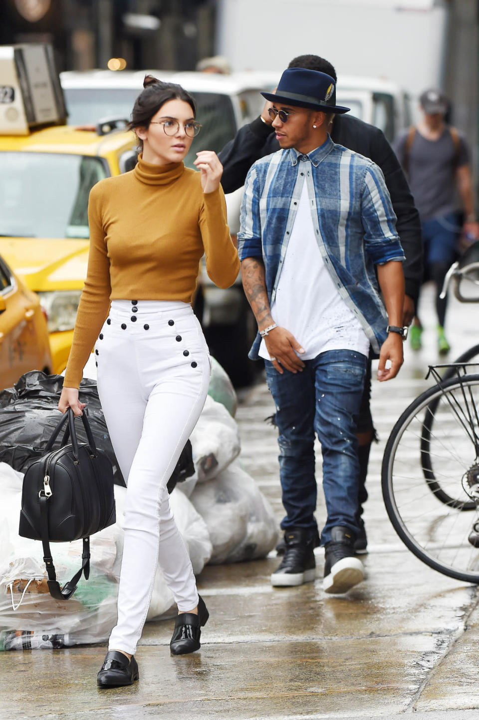 <p>Jenner looked fabulously four-eyed in round glasses, high-waisted white pants, and a mustard-colored turtle neck in New York City. She completed the casual look with her favorite black Givenchy tote (duh) and flats. </p>