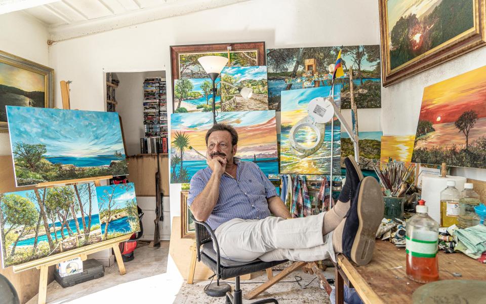 Roberto Escobar surrounded by his paintings at home in Majorca last month - Bruno Daureo