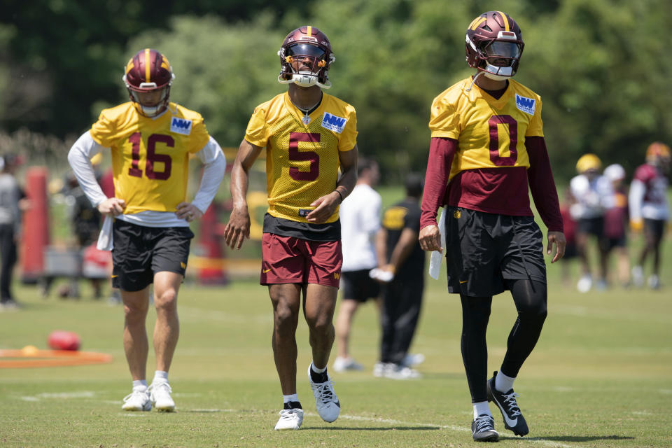 From left; Washington Commanders quarterbacks Jeff Driskel, (16) Javden Daniels (5) and Marcus Mariota, (0) during NFL football practice in Ashburn, Va., Wednesday, May 22, 2024. (AP Photo/Jose Luis Magana)