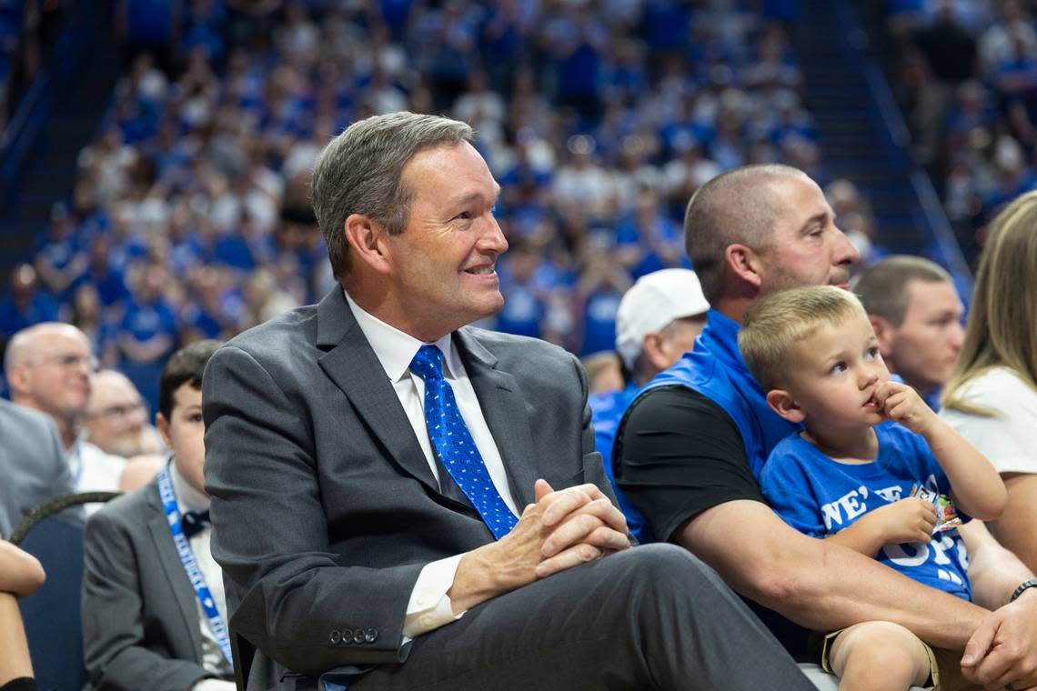 UK athletics director Mitch Barnhart smile as Mark Pope speaks at his introductory press conference Sunday in Rupp Arena.