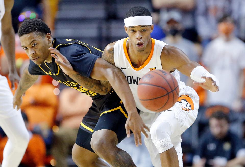 Oklahoma State's Avery Anderson III (0) steals the ball from Wichita State's Qua Grant (22) in the first half during the college basketball game between the Oklahoma State Cowboys and the Wichita State Shockers at Gallagher-Iba Arena, Wednesday, Dec. 1, 2021. 