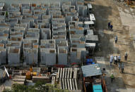 Workers walk past prefabricated building units as they clean up the construction site where locally transmitted Zika cases were first discovered in Singapore August 31, 2016. REUTERS/Edgar Su