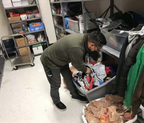 With a chill descending, Mountain View Elementary School parent educator Ted Pedro grabbed child-sized items from the school’s store of winter clothes. (Kevin Mahnken/The 74)