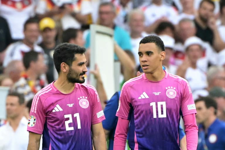 Midfielders Ilkay Gundogan Jamal Musiala in Germany's pink and purple jerseys after winning the UEFA Euro 2024 Group A football match against Hungary on June 19 (DAMIEN MEYER)