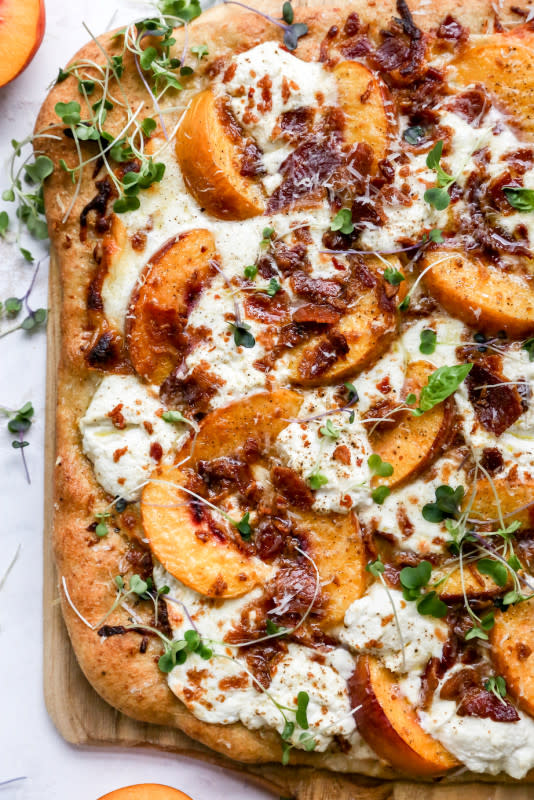 <p>Yes to Yolks</p><p>This peach and bacon white pizza with ricotta is everything summer should be in one carby package. It’s gooey and cheesy, garlicky, loaded with juicy, sweet peaches and has a salty bite from crumbled bacon.</p><p><strong>Get the recipe: <a href="https://yestoyolks.com/2020/09/02/peach-bacon-white-pizza-with-ricotta/" rel="nofollow noopener" target="_blank" data-ylk="slk:Peach and Bacon White Pizza with Ricotta;elm:context_link;itc:0;sec:content-canvas" class="link ">Peach and Bacon White Pizza with Ricotta</a></strong></p>
