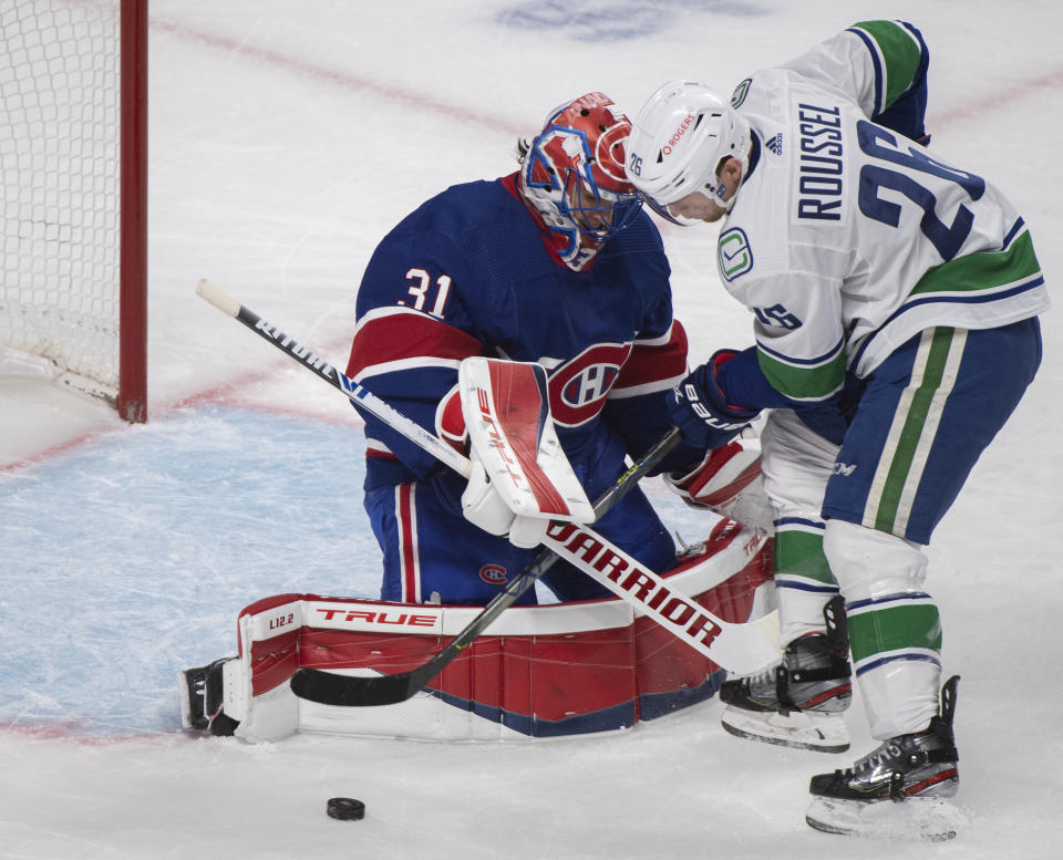 Vancouver Canucks' Antoine Roussel moves in on Montreal Canadiens goaltender Carey Price during the second period of an NHL hockey game Saturday, March 20, 2021, in Montreal. (Graham Hughes/The Canadian Press via AP)
