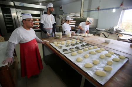 Men with special needs bake bread in the southern city of Tyre, Lebanon December 18, 2018. Picture taken December 18, 2018. REUTERS/Ali Hashisho