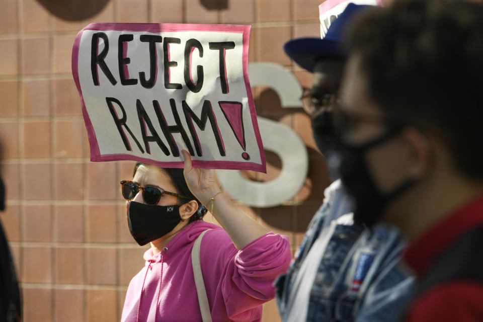 Danaka Katovich of Code Pink, holds a sign during a rally to protest former Chicago Mayor Rahm Emanuel's ambassador to Japan appointment outside the Chicago Police Headquarters Tuesday, Oct. 19, 2021, in Chicago. The fatal police shooting of a Black teen in Chicago seven years ago is looming large over the city’s former mayor, Emanuel, as he looks to win confirmation as President Joe Biden’s ambassador to Japan. (AP Photo/Paul Beaty)