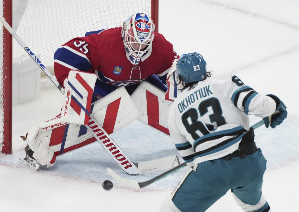 San Jose Sharks' Nikita Okhotiuk (83) scores on Montreal Canadiens goaltender Sam Montembeault (35) during the second period of an NHL hockey game in Montreal on Thursday, Jan. 11, 2024. (Christinne Muschi/The Canadian Press via AP)
