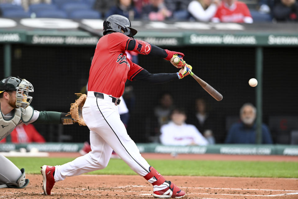 Cleveland Guardians' Andrés Giménez hits an RBI single during the third inning of a baseball game against the Oakland Athletics, Sunday, April 21, 2024, in Cleveland. (AP Photo/Nick Cammett)