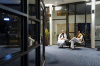 Taliban delegate Shafiullah Azam, Taliban vice director for economic cooperation ministry foreign affairs, right, sits in a hotel in Oslo, Norway, Sunday, Jan. 23, 2022. A Taliban delegation led by acting Foreign Minister Amir Khan Muttaqi on Sunday started three days of talks in Oslo with Western officials and Afghan civil society representatives amid a deteriorating humanitarian situation in Afghanistan. The closed-door meetings are taking place at a hotel in the snow-capped mountains above the Norwegian capital. (Torstein Boe/NTB scanpix via AP)