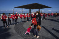 A group of women stand along the beach, commemorating International Women's Day by calling for the release of hostages held by Hamas in the Gaza Strip in Tel Aviv, Israel, March 8, 2024. Some 130 hostages remain in Gaza as the Israel-Hamas war enters its sixth month, and Israel's government says 19 of them are women. (AP Photo/Oded Balilty)