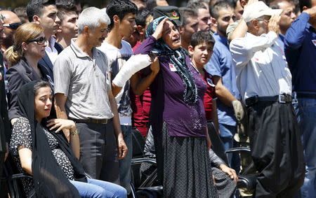 Seher Nane (L), widow of Turkish Army officer Mehmet Yalcin Nane who was killed by Islamic State militants on Thursday, and relatives mourn during a ceremony at a military base in Gaziantep, July 24, 2015. REUTERS/Murad Sezer