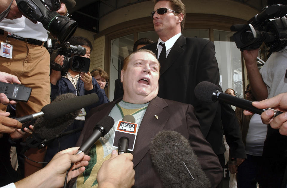 FILE - "Hustler" magazine founder and gubernatorial candidate Larry Flynt talks to reporters as he arrives to cast his vote in the recall election, Tuesday, Oct. 7, 2003, in West Hollywood, Calif. Flynt, who turned "Hustler" magazine into an adult entertainment empire while championing First Amendment rights, has died at age 78. His nephew, Jimmy Flynt Jr., told The Associated Press that Flynt died Wednesday, Feb. 10, 2021, of heart failure at his Hollywood Hills home in Los Angeles. (AP Photo/Rene Macura, File)