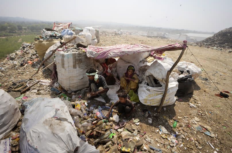 Waste picker Arjun, 6, sorts recyclable items with his parents 