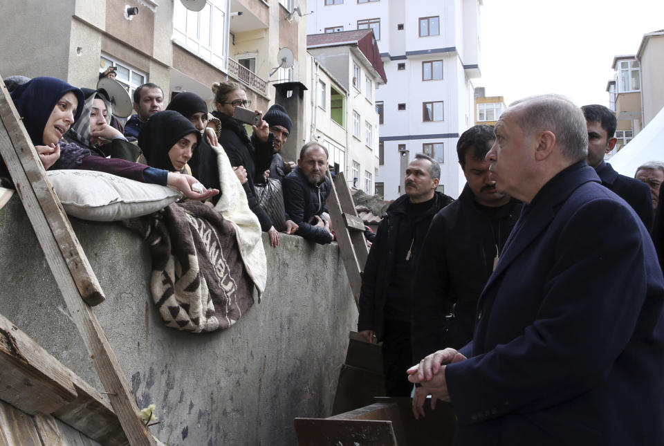 Turkey's President Recep Tayyip Erdogan speaks to people as he visits the site of a collapsed building in Istanbul, Saturday, Feb. 9, 2019. Erdogan says there are "many lessons to learn" from the collapse of a residential building in Istanbul where at least 17 people have died. (Presidential Press Service via AP, Pool)