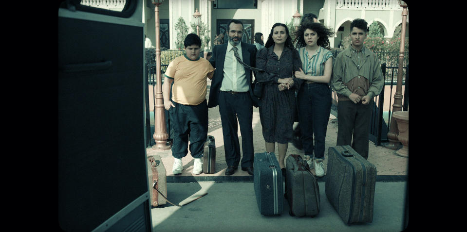 In a flashback, Mo's family lines up in front of a bus to leave Kuwait.<span class="copyright">Courtesy of Netflix</span>