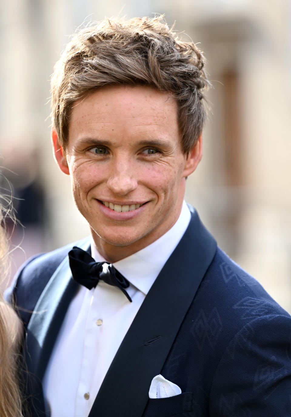 Clean-shaven Eddie in a bow tie and suit and smiling