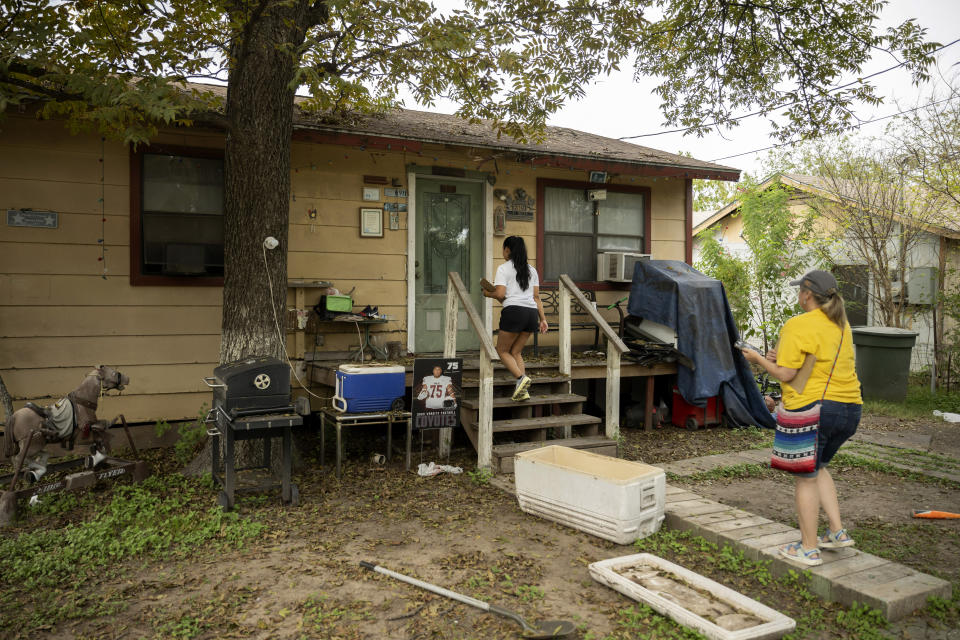 Mayoral candidate Kimberly Mata-Rubio, left, and campaign manager Dr. Laura Barberena, canvass a neighborhood in support of Mata-Rubio's campaign, Saturday, Oct. 21, 2023, in Uvalde, Texas. (AP Photo/Darren Abate)