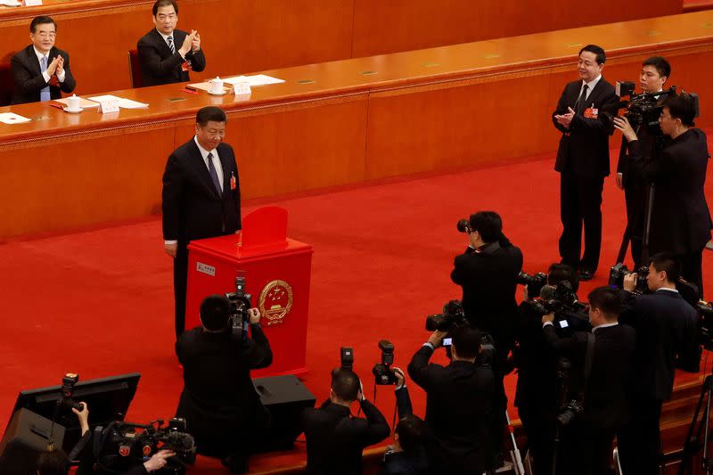 FILE PHOTO: Chinese President Xi Jinping pauses after casting his ballot in Beijing
