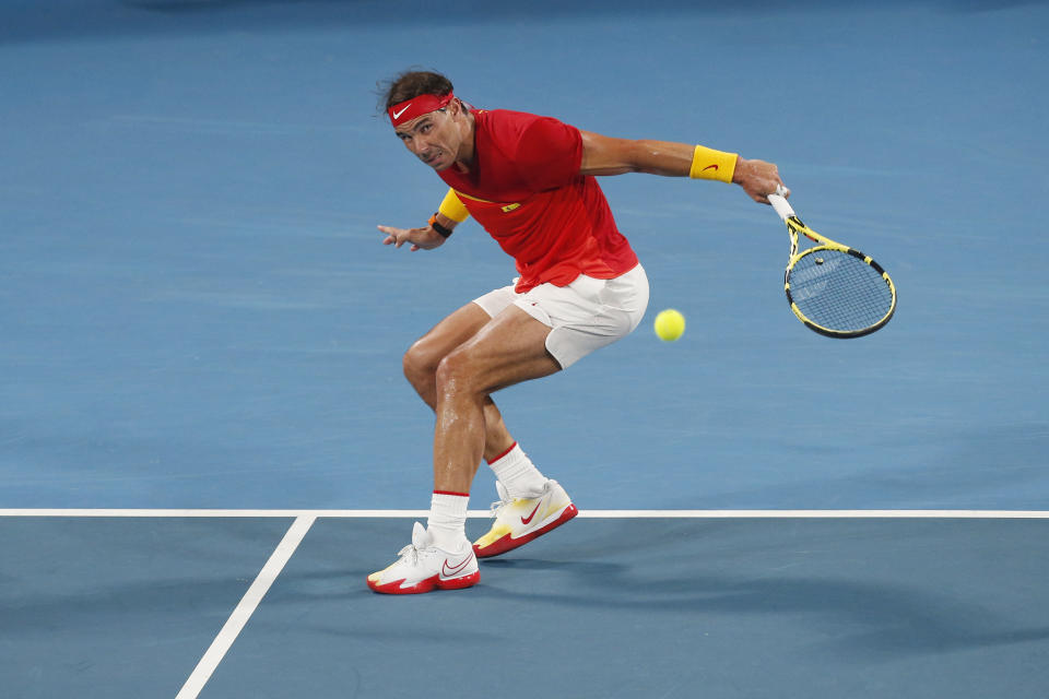 Rafael Nadal of Spain plays a shot against Novak Djovovic of Serbia during their ATP Cup tennis match in Sydney, Sunday, Jan. 12, 2020. (AP Photo/Steve Christo)