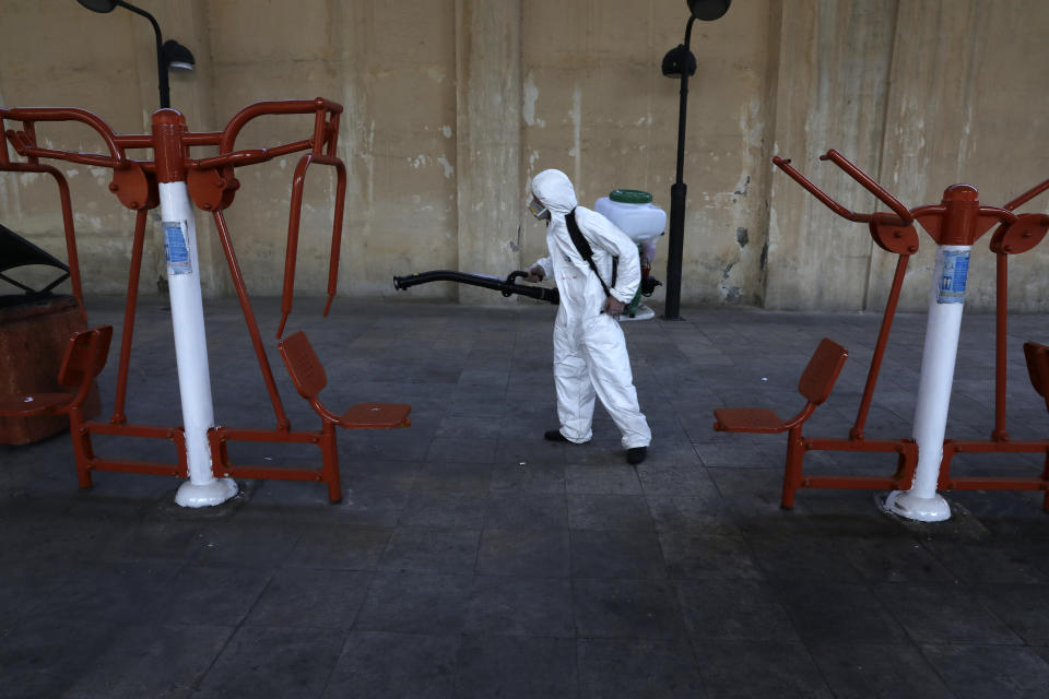 A firefighter disinfects public exercise equipment to help prevent the spread of the new coronavirus in Tehran, Iran, Thursday, March 5, 2020. Iran has one of the highest death tolls in the world from the new coronavirus outside of China, the epicenter of the outbreak. (AP Photo/Vahid Salemi)