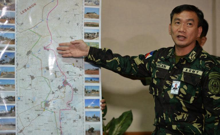 Philippine Colonel, Roberto Ancan, points to a map of the Golan Heights where Philippine UN peacekeepers are in a stand-off with Syrian rebels, during a press conference in Manila, on August 29, 2014