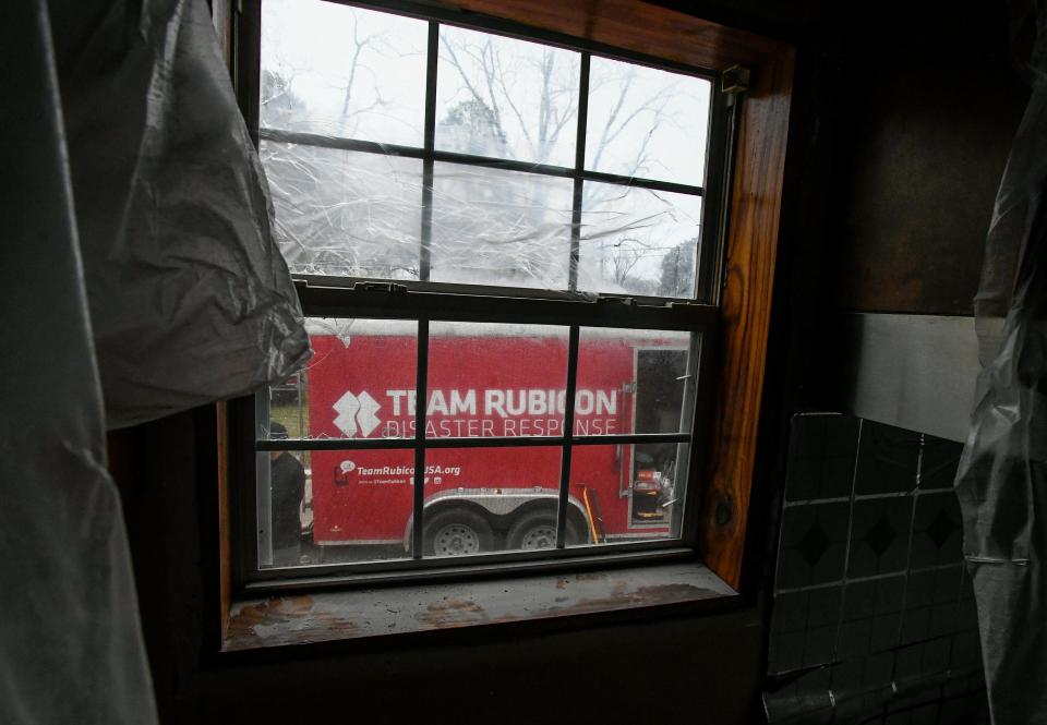 A Team Rubicon equipment trailer sits outside a home as workers with the Rebuild Selma project do repair work on homes with longstanding storm damage in Selma, Ala., on Saturday February 26, 2022.