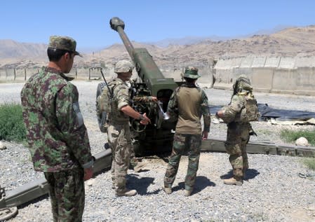 FILE PHOTO: U.S. military advisers from the 1st Security Force Assistance Brigade work with Afghan soldiers at an artillery position on an Afghan National Army base in Maidan Wardak province