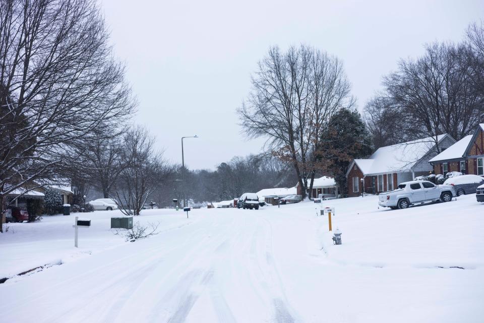 Snow is seen on the street and yards of homes in the Raleigh area on Dr. Martin Luther King Day on Monday, Jan. 15, 2024. The Memphis area is expecting 3 to 6 inches of snow and below-freezing temperatures.