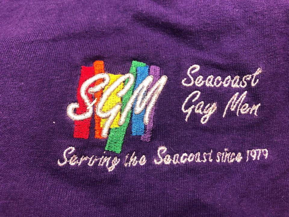 The embroidered logo on a T-shirt for the Seacoast Gay Men, a group founded in 1979. T-shirts, banners, photos, posters, pins, pamphlets, flyers and other items can be found in the Portsmouth Athenaeum archives.