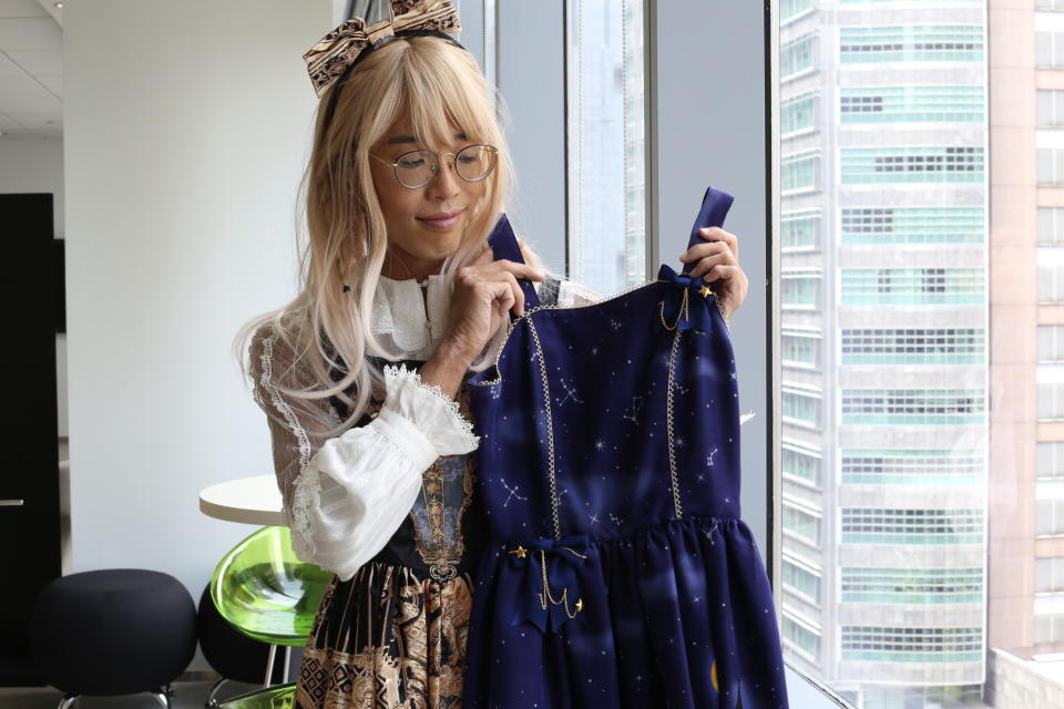 Kerraine, 36, holding up a jumper skirt she bought from Japanese Lolita fashion brand Innocent World. (Photo: Nurul Azliah/ Yahoo Lifestyle Singapore)