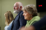 European Commissioners for European Green Deal Frans Timmermans, center, and European Commissioner for Cohesion and Reforms Elisa Ferreira, right, listens to questions during a joint video press conference on Green and Just recovery at the EU headquarters in Brussels, Thursday, May 28, 2020. (Aris Oikonomou/Pool Photo via AP)