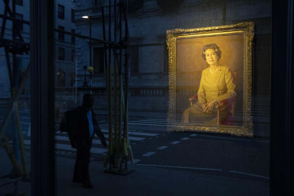 A man walks past a painting of Queen Elizabeth II displayed at a gallery in London, Sept. 10, 2022. (AP Photo/Felipe Dana)