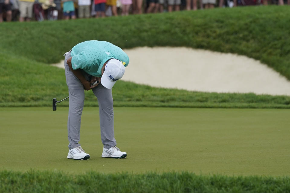 Collin Morikawa reacts after missing a putt on the first playoff hole during the final round of the Memorial golf tournament, Sunday, June 6, 2021, in Dublin, Ohio. (AP Photo/Darron Cummings)