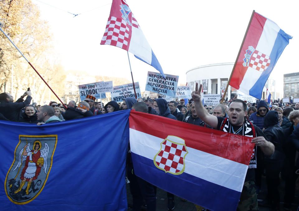 People march down a street during a protest against vaccination and coronavirus measures in Zagreb, Croatia, Saturday, Nov. 20, 2021. Thousands of protesters gathered in Zagreb on Saturday after, earlier this month, authorities introduced more restrictive measures to fight the surge of coronavirus infections in the country. (AP Photo)