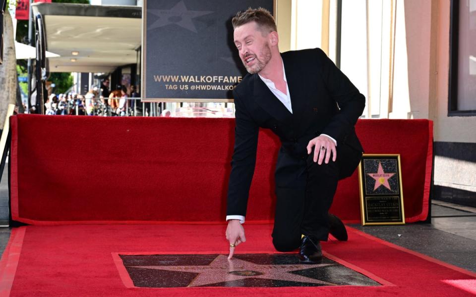 US actor Macaulay Culkin gestures near his newly unveiled Hollywood Walk of Fame Star in Hollywood, California, on December 1, 2023. (AFP via Getty Images)