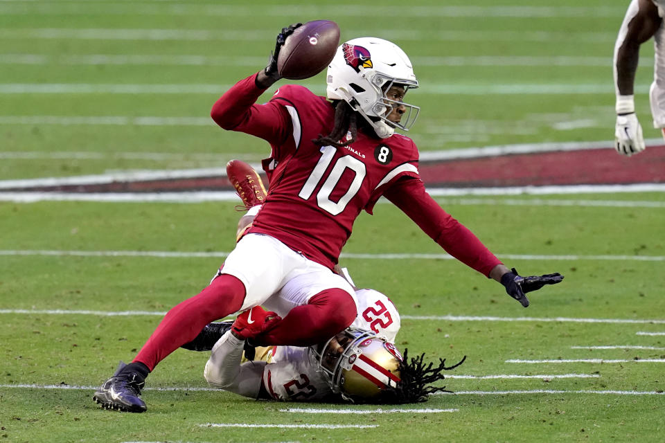 Arizona Cardinals wide receiver DeAndre Hopkins (10) is tackled by San Francisco 49ers cornerback Jason Verrett (22) during the first half of an NFL football game, Saturday, Dec. 26, 2020, in Glendale, Ariz. (AP Photo/Ross D. Franklin)