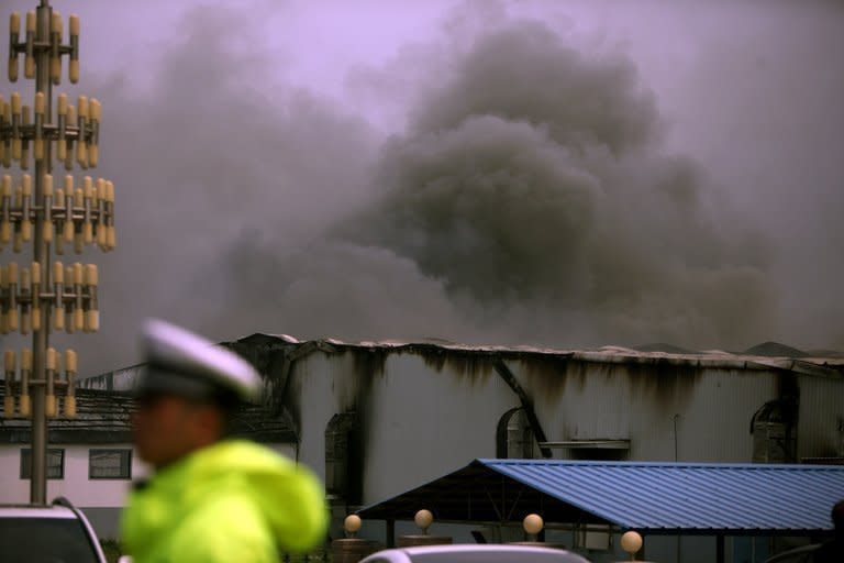 Smoke rises from the Baoyuanfeng poultry plant in Dehui, China's Jilin province, on June 3, 2013. Survivors of an inferno at a Chinese poultry processing plant have described their desperate attempts to save others, as relatives of the 119 people killed demanded answers from authorities