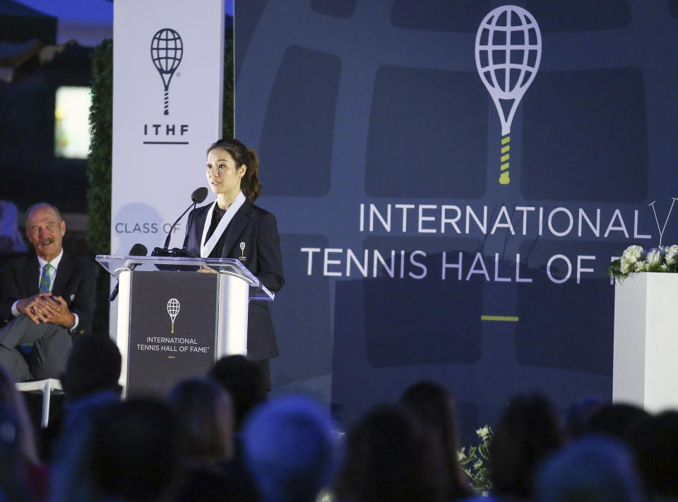 Tennis Hall of Fame inductee Li Na, of China, speaks to the crowd during ceremonies at the International Tennis Hall of Fame, Saturday, July 20, 2019, in Newport, R.I. (AP Photo/Stew Milne)