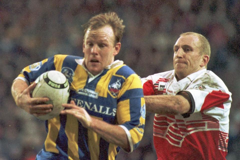 Greg Mackey looks to escape the clutches of Wigan's Shaun Edwards <i>(Image: Newsquest)</i>