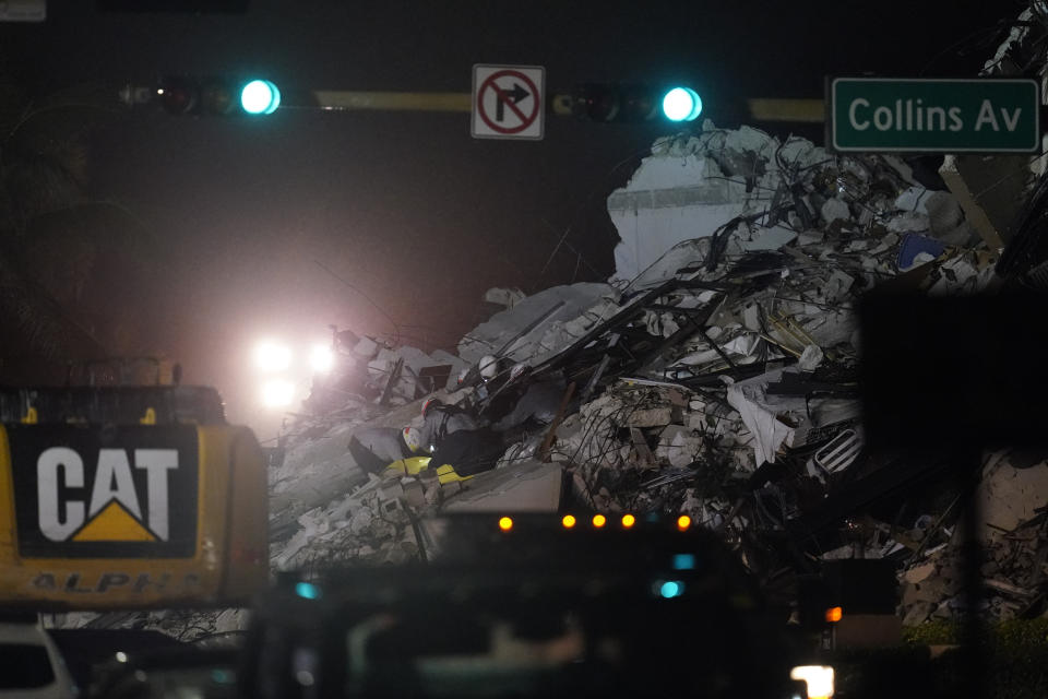 Rescue workers search through the rubble where a wing of a 12-story beachfront condo building collapsed, Thursday, June 24, 2021, in the Surfside area of Miami.(AP Photo/Gerald Herbert)