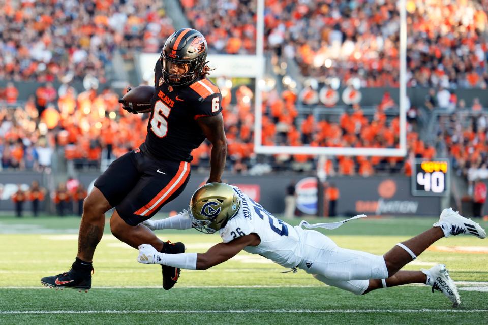 Oregon State Beavers running back Damien Martinez (6) escapes a tackle by UC Davis Aggies defensive back Lamont Hamburger (26) during the second half at Reser Stadium Sept. 9 in Corvallis.