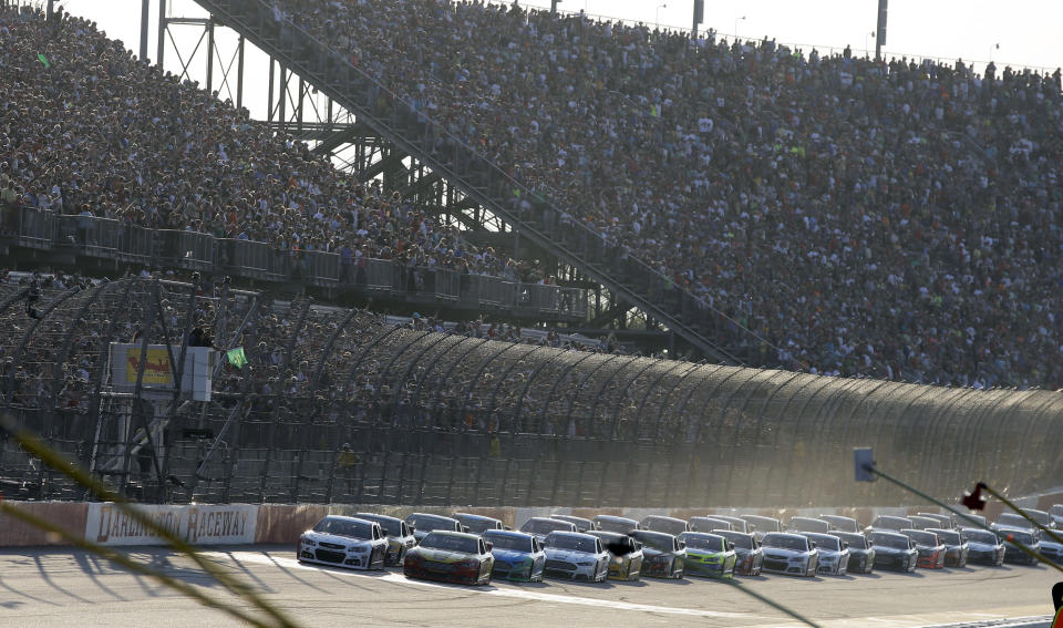 The field takes the green flag to start the NASCAR Sprint Cup auto race at Darlington Speedway in Darlington, S.C., Saturday, April 12, 2014. (AP Photo/Chuck Burton)