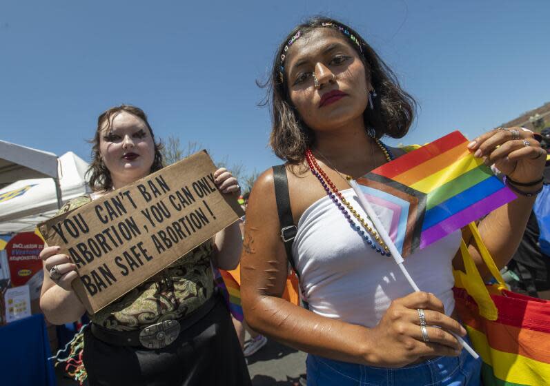 Showing what they think of the recent Supreme Court ruling, Elleana Tanner, left, of Laguna Hills, and Alejandra Barba, right, of Orange attend the OC Pride Festival in Santa Ana on Saturday, June 25, 2022. (Photo by Paul Rodriguez)