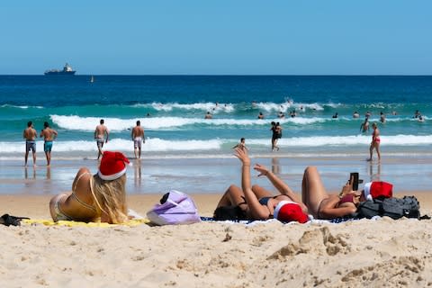 Santa hats at Bondi Beach - Credit: getty